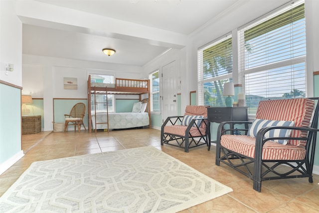 bedroom featuring ornamental molding and light tile patterned flooring