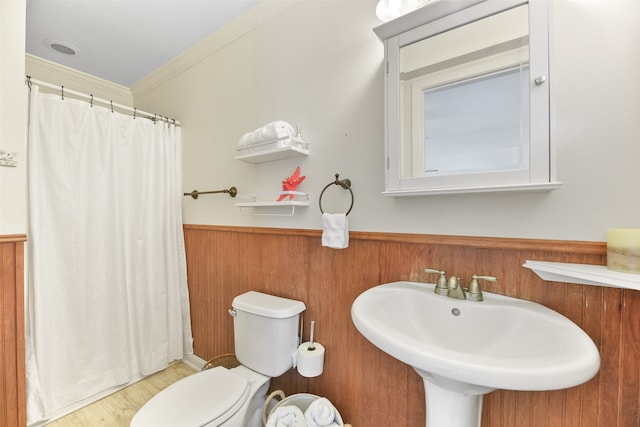 bathroom featuring sink, ornamental molding, a shower with curtain, wood-type flooring, and toilet