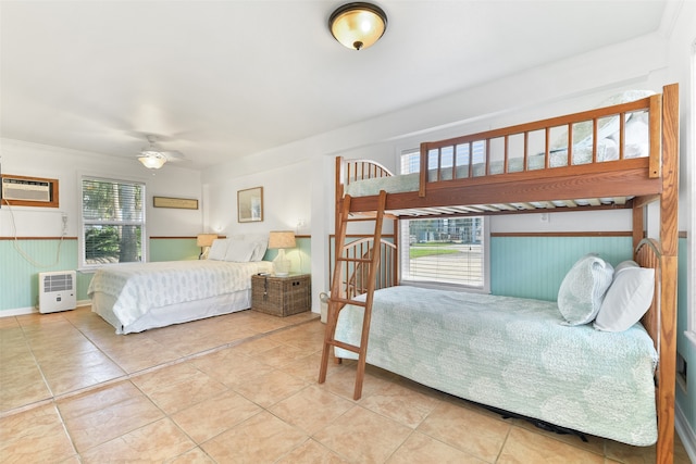 bedroom featuring a wall unit AC and ceiling fan