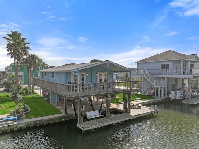 dock area with a yard and a deck with water view