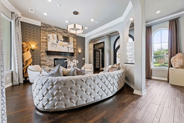 interior space featuring a fireplace, dark hardwood / wood-style flooring, and ornamental molding