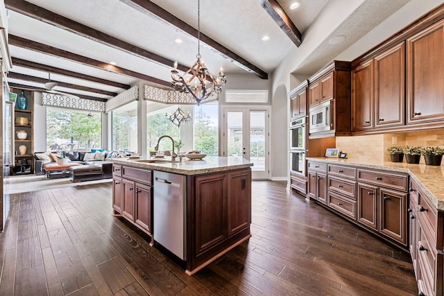 kitchen featuring dark hardwood / wood-style flooring, stainless steel appliances, sink, pendant lighting, and beamed ceiling