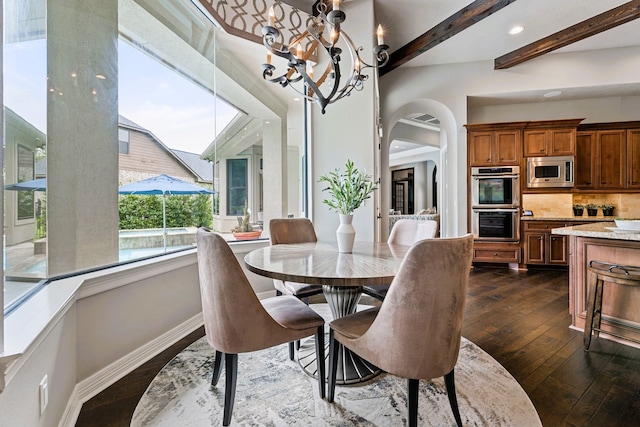 dining room featuring beam ceiling, dark hardwood / wood-style flooring, and an inviting chandelier