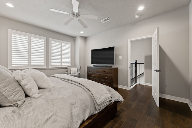 bedroom featuring a textured ceiling, dark hardwood / wood-style flooring, and ceiling fan