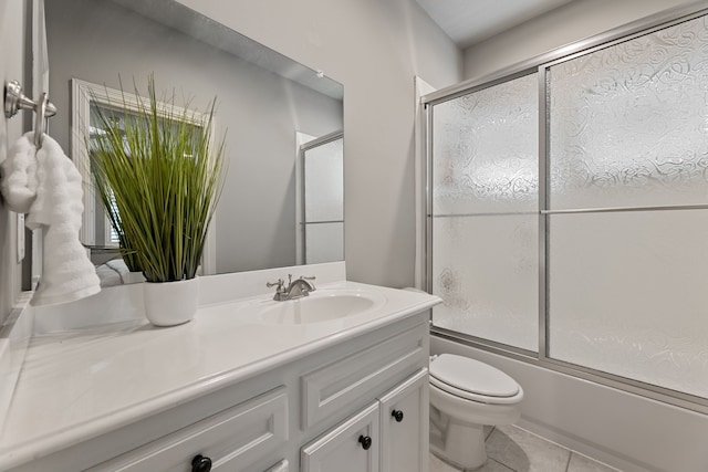 full bathroom featuring tile patterned flooring, vanity, toilet, and enclosed tub / shower combo