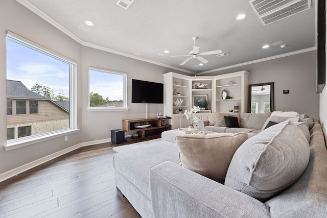 living room featuring ceiling fan, hardwood / wood-style floors, and ornamental molding