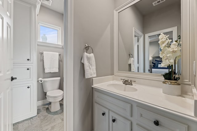 bathroom featuring vanity and toilet