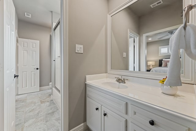 bathroom with combined bath / shower with glass door, vanity, and ceiling fan