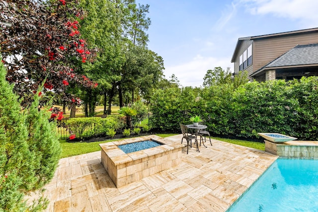 view of swimming pool featuring an in ground hot tub and a patio area