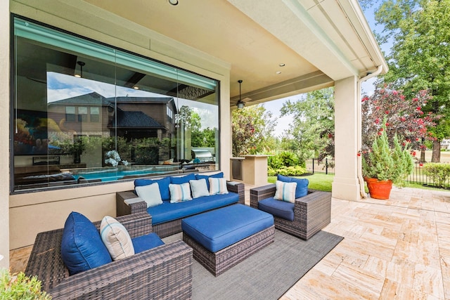 view of patio with an outdoor living space and ceiling fan