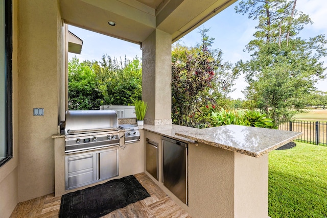 view of patio with area for grilling and exterior kitchen