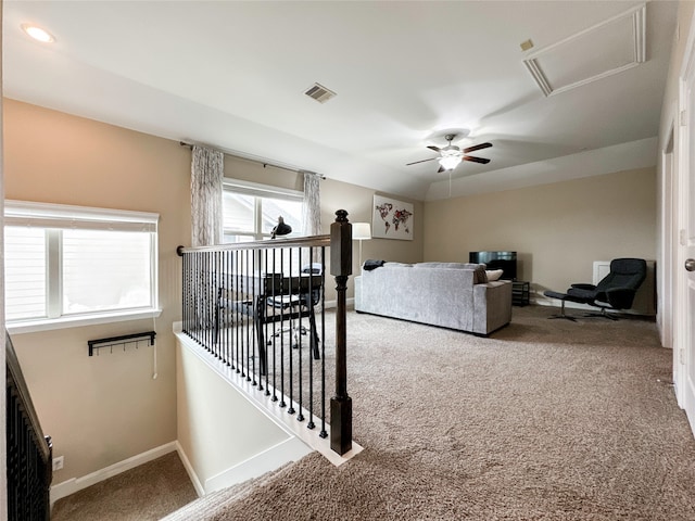 carpeted living room with ceiling fan