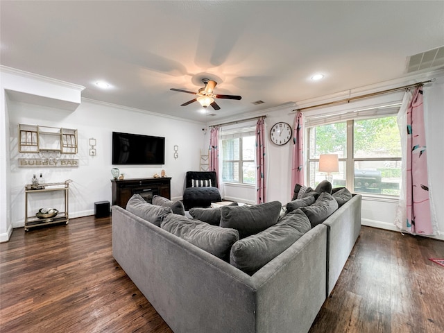 living room with dark hardwood / wood-style flooring, ceiling fan, and crown molding