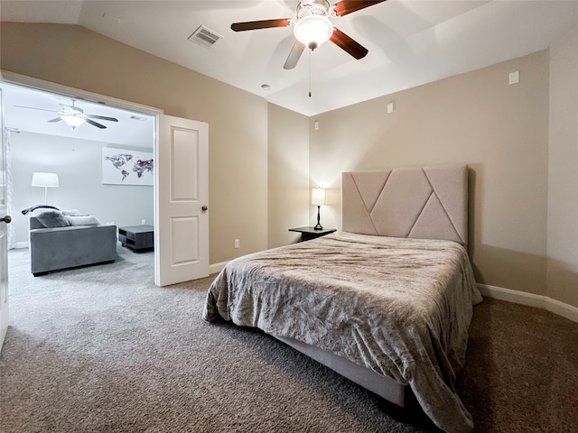 bedroom with ceiling fan, vaulted ceiling, and carpet