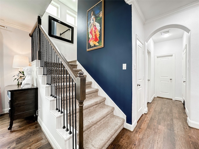 stairway with hardwood / wood-style flooring and ornamental molding