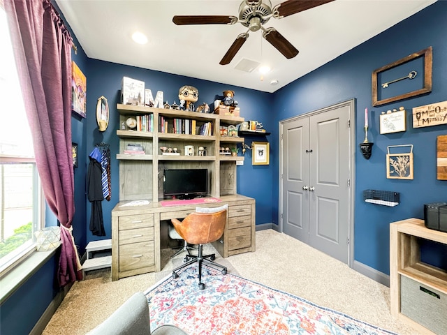 carpeted home office with ceiling fan