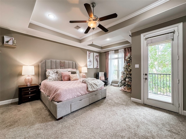 carpeted bedroom with ceiling fan, a raised ceiling, access to exterior, and crown molding