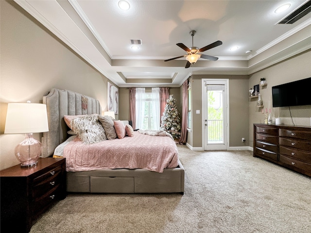 carpeted bedroom with access to outside, a tray ceiling, ceiling fan, and crown molding