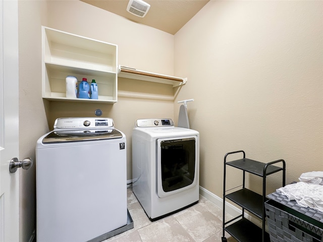 washroom with separate washer and dryer and light tile patterned floors