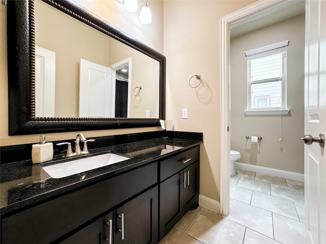 bathroom with vanity, tile patterned flooring, and toilet