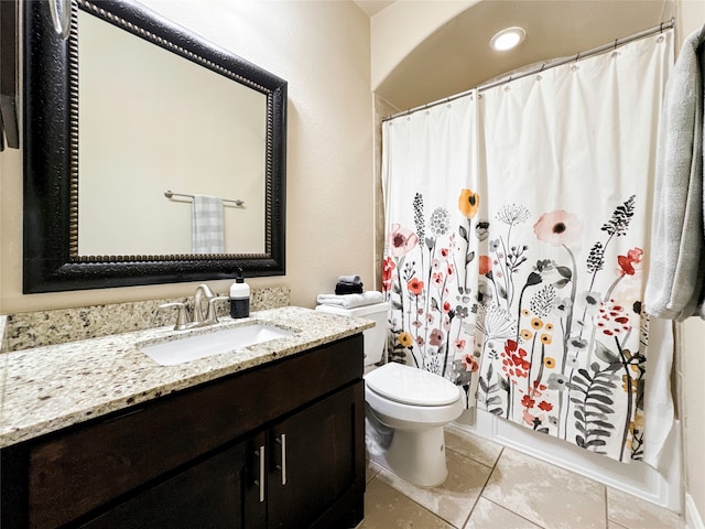 bathroom featuring toilet, walk in shower, vanity, and tile patterned floors