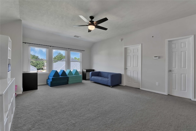 unfurnished living room featuring ceiling fan, a textured ceiling, and carpet flooring