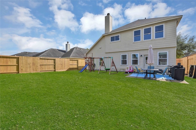 back of property featuring a playground, a lawn, and a patio