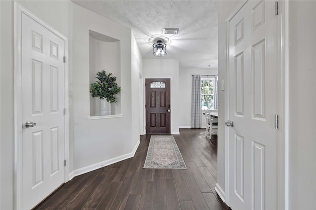 entryway featuring dark hardwood / wood-style floors and a textured ceiling