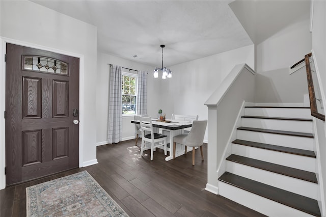 entryway with a notable chandelier and dark hardwood / wood-style floors