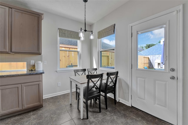 dining area with dark tile patterned flooring