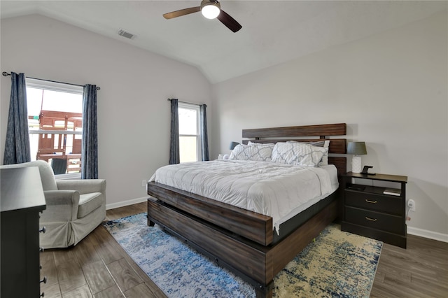 bedroom with multiple windows, dark hardwood / wood-style floors, and ceiling fan