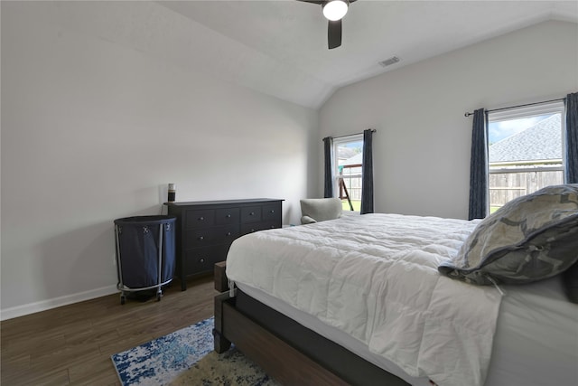 bedroom with dark wood-type flooring, ceiling fan, and vaulted ceiling