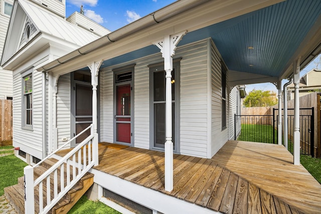 property entrance with fence and a porch