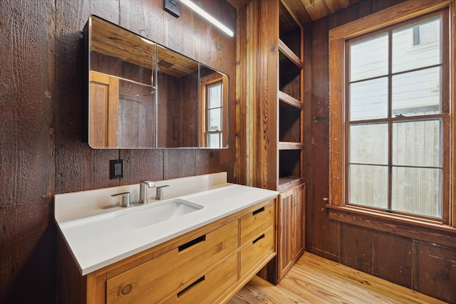 bathroom featuring wood-type flooring and wooden walls