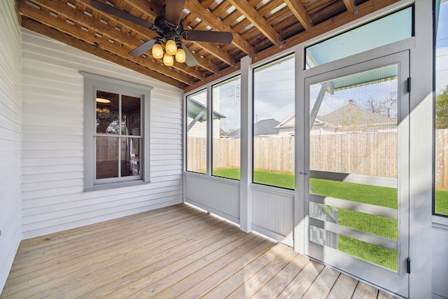 unfurnished sunroom featuring lofted ceiling with beams, wood ceiling, and ceiling fan