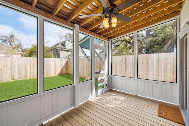 unfurnished sunroom with ceiling fan, beam ceiling, and wood ceiling