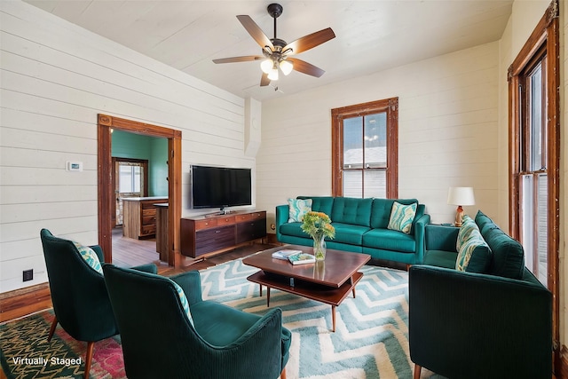 1214 Crockett St, Houston, TX 77007 - living area with wood finished floors, wooden walls, and a ceiling fan