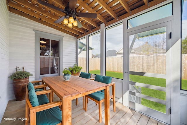 sunroom / solarium with ceiling fan, wood ceiling, and vaulted ceiling with beams