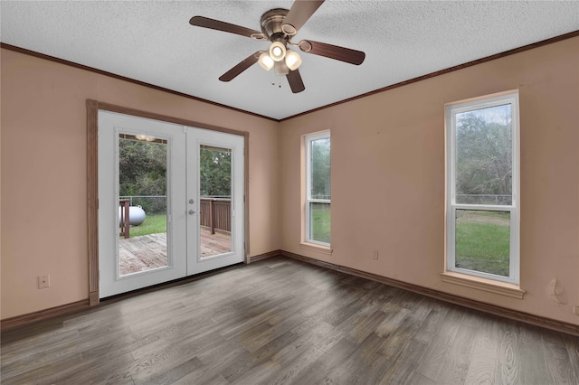 unfurnished room with hardwood / wood-style floors, ceiling fan, plenty of natural light, and french doors