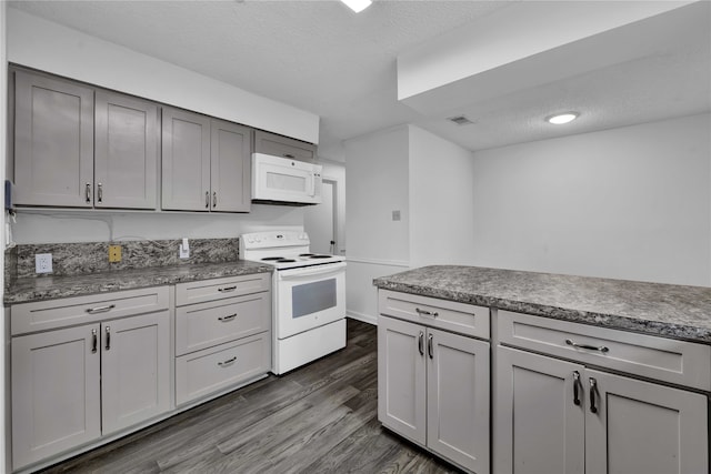 kitchen featuring gray cabinets, dark hardwood / wood-style flooring, a textured ceiling, and white appliances