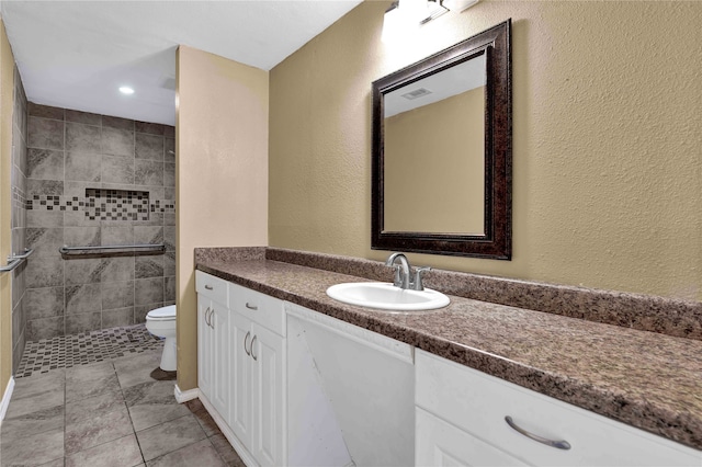 bathroom featuring toilet, vanity, and tile patterned floors