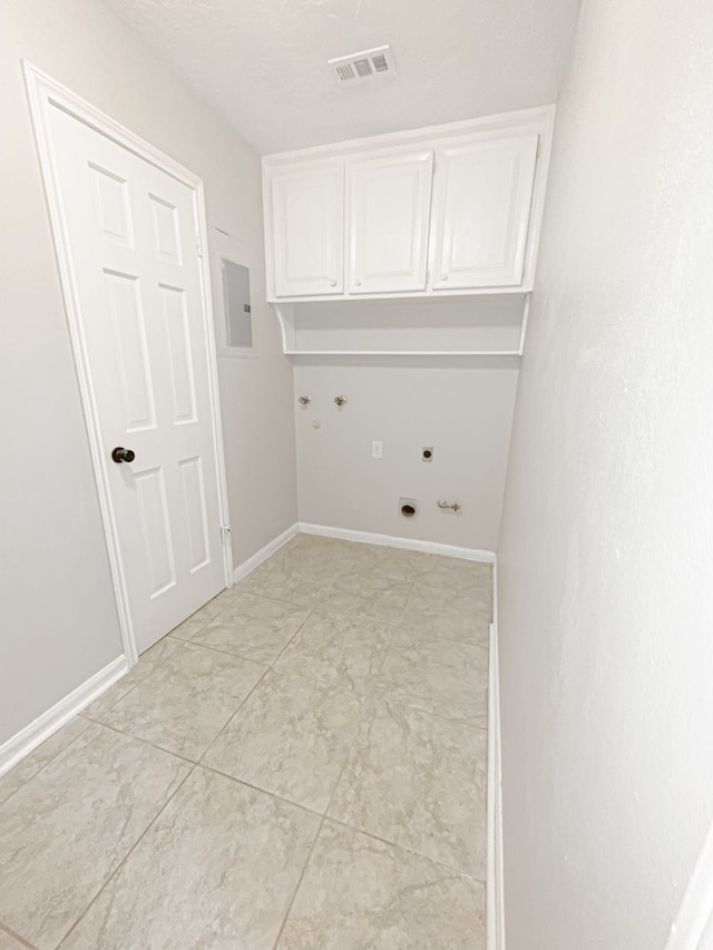 clothes washing area featuring cabinets, electric panel, hookup for a gas dryer, washer hookup, and hookup for an electric dryer