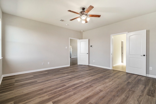 unfurnished bedroom with ceiling fan and dark hardwood / wood-style floors