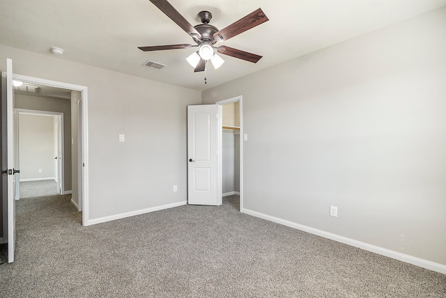 unfurnished bedroom featuring ceiling fan and carpet