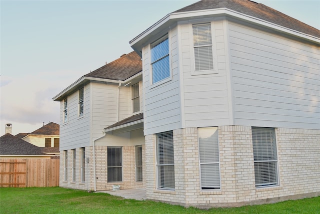 back of house with a lawn