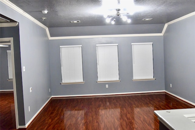 empty room with dark hardwood / wood-style flooring, a textured ceiling, vaulted ceiling, and crown molding