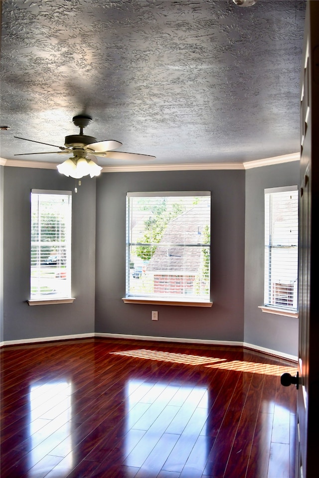 unfurnished room featuring hardwood / wood-style floors, plenty of natural light, and a textured ceiling