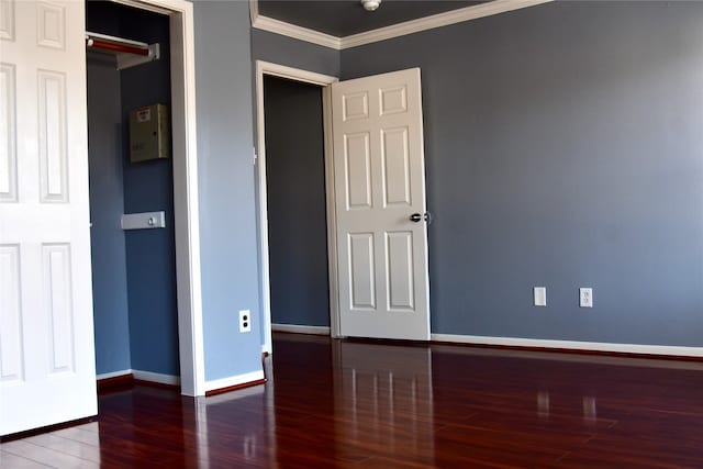 unfurnished bedroom featuring dark hardwood / wood-style floors and crown molding