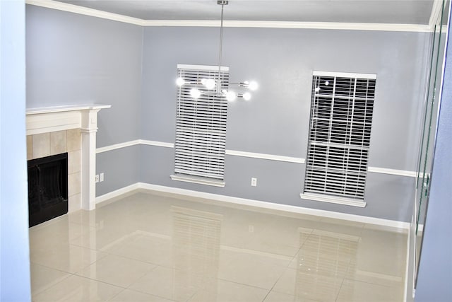 unfurnished dining area with a tiled fireplace, tile patterned floors, and crown molding