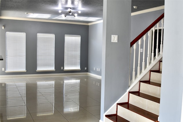 stairway featuring a chandelier, a textured ceiling, tile patterned flooring, and crown molding